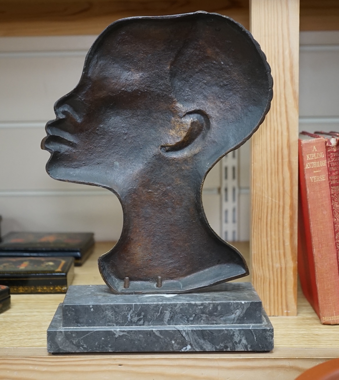 An Art Deco Hagenauer style bronze study of an African lady, stepped marble base, 28cm. Condition - earring missing